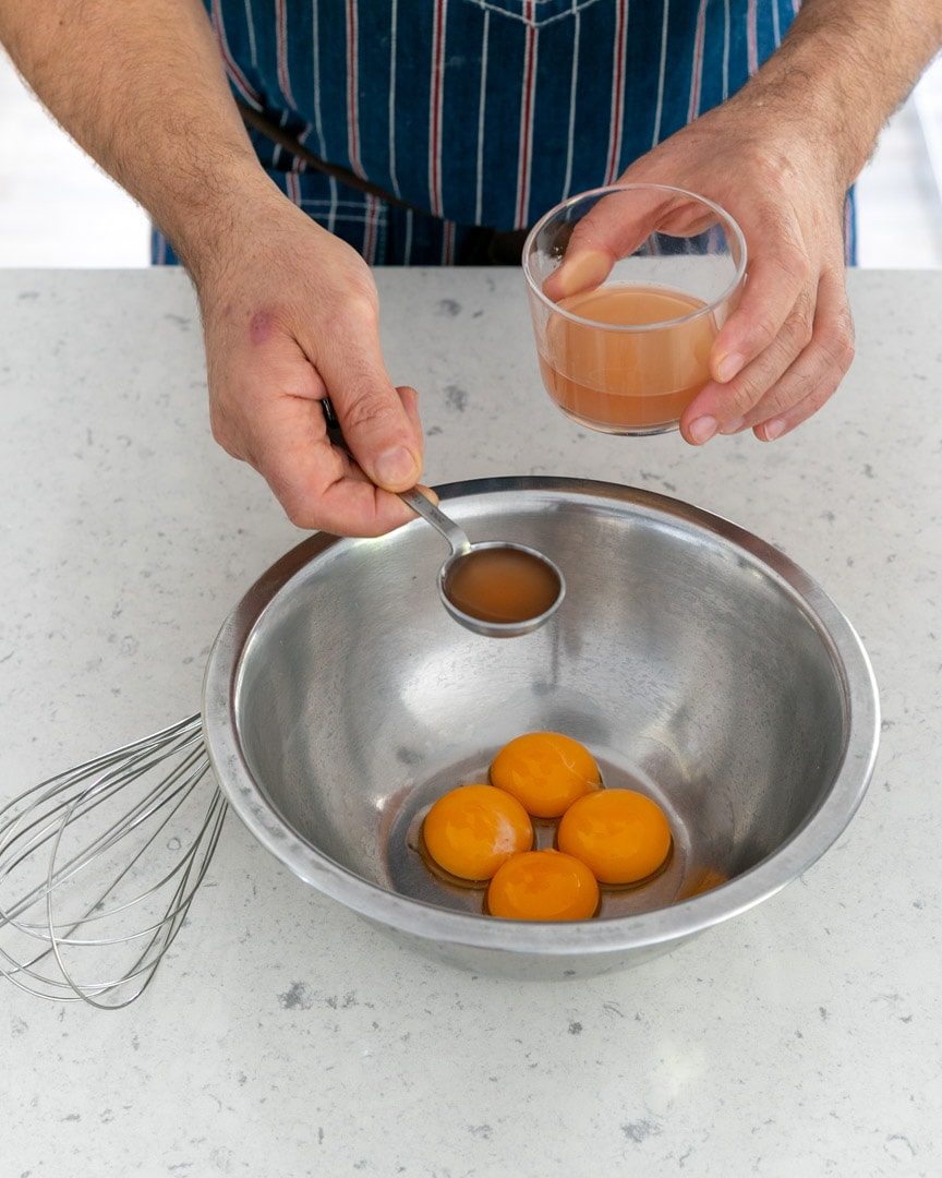 Adding reduction and vinegar to egg yolks