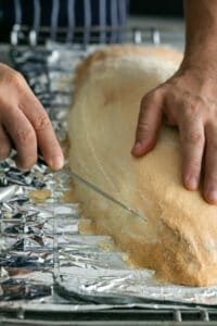 How to open the crust of the Whole baked Barramundi