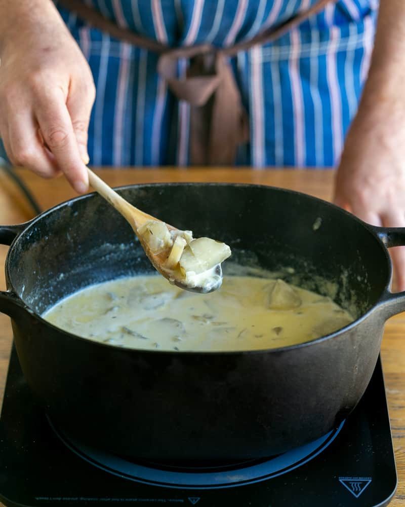 Cooked jerusalem artichokes on a wooden spoon for soup