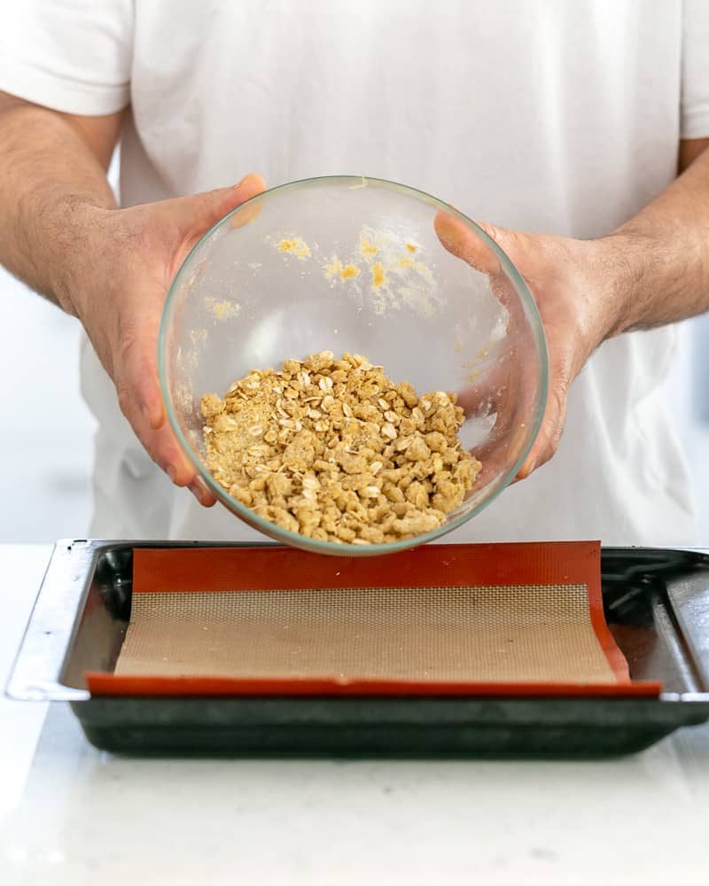 Person showing texture of oat crumble before baking