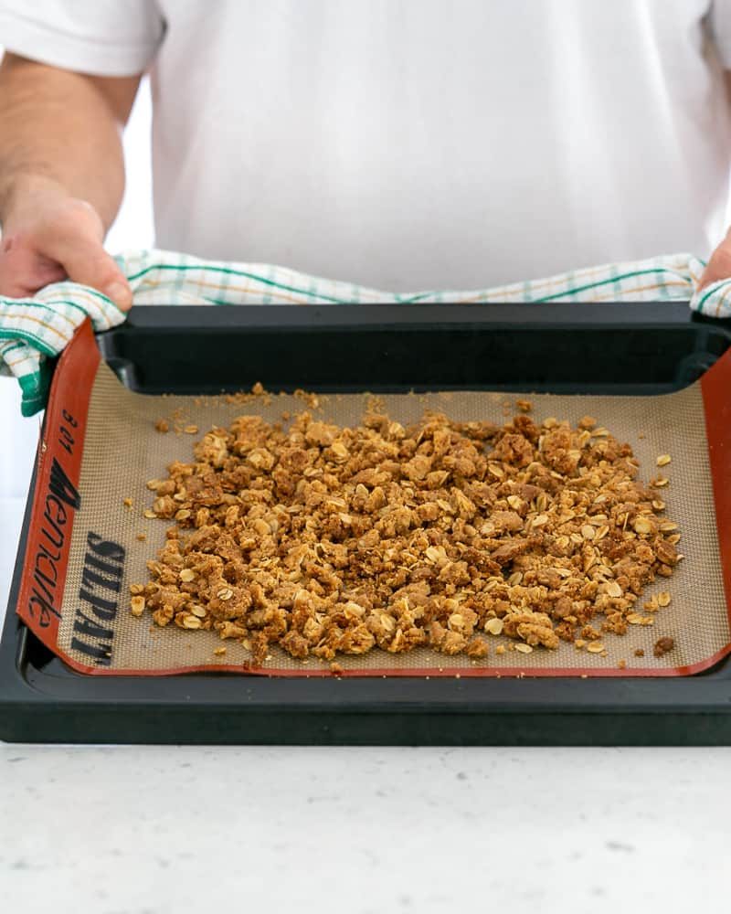 Baked oat crumble on a baking tray straight out of the oven