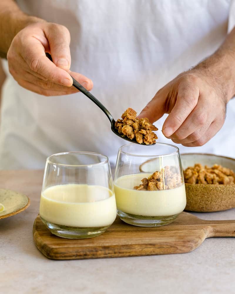 Oat crumble topping on lemon yuzu posset in glass