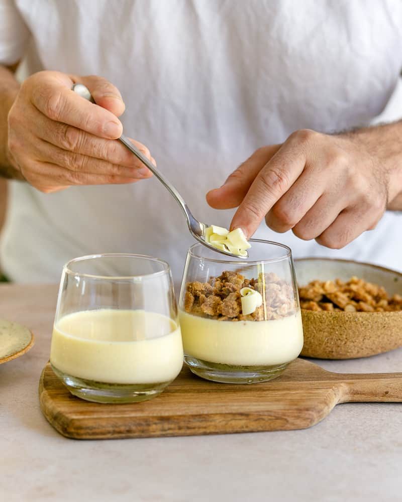 White chocolate shavings added on top of the yuzu lemon posset with crumble