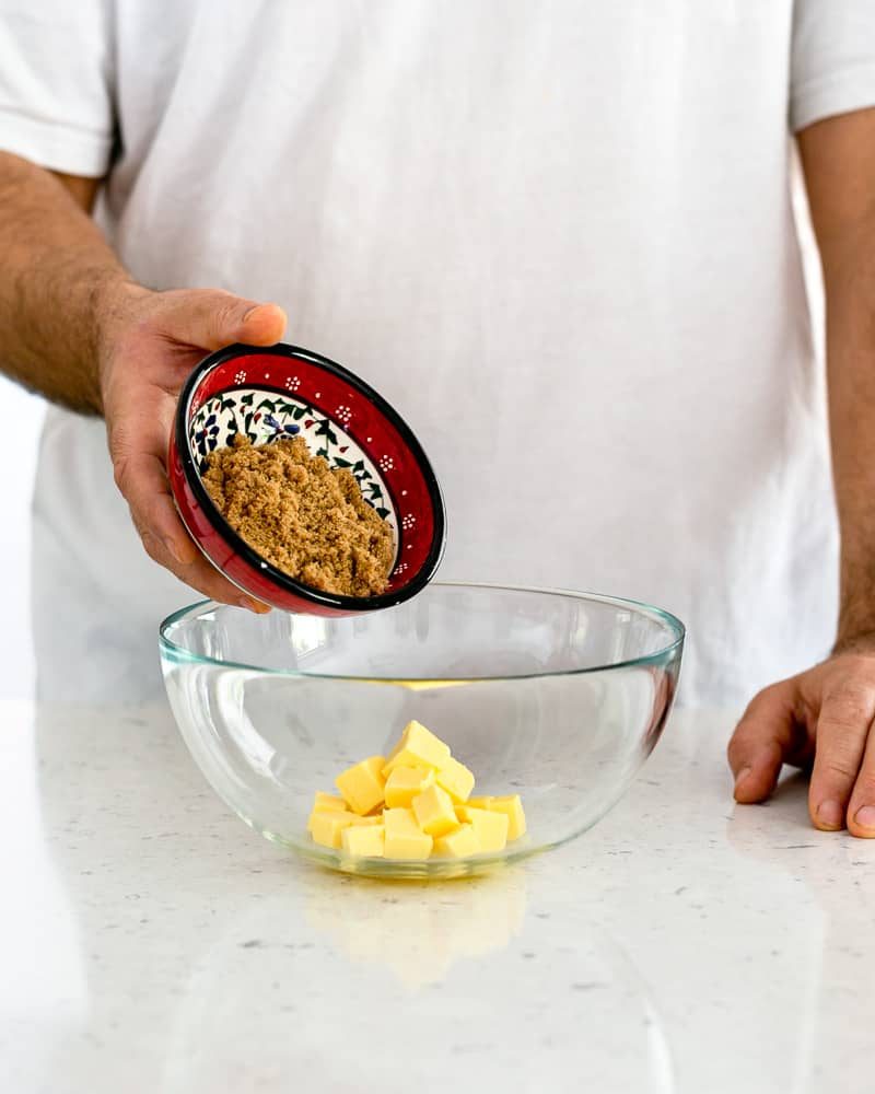 To make the oat crumble person adding brown sugar to butter in a bowl