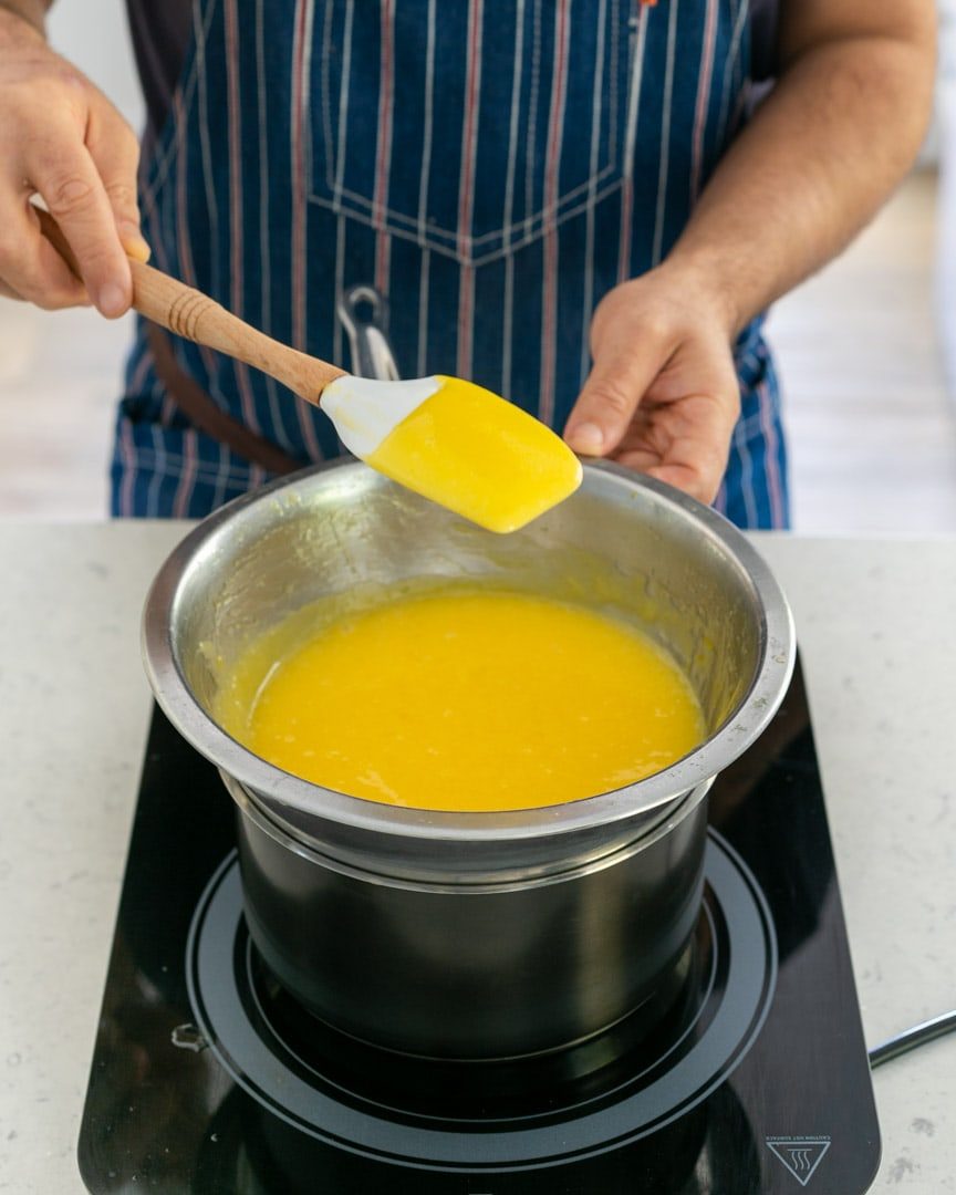 Lemon curd coating the back of a spoon when ready