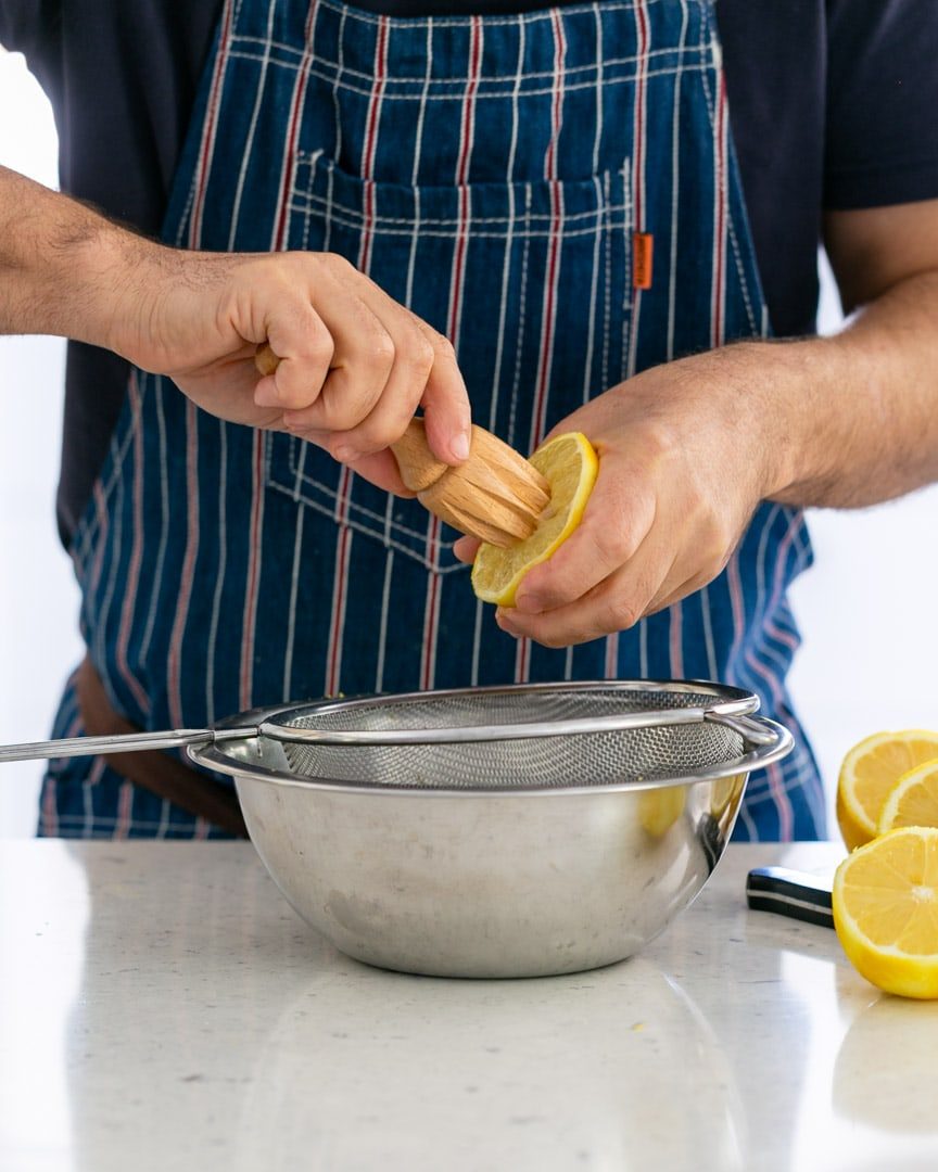 Squeezing lemon juice for lemon curd