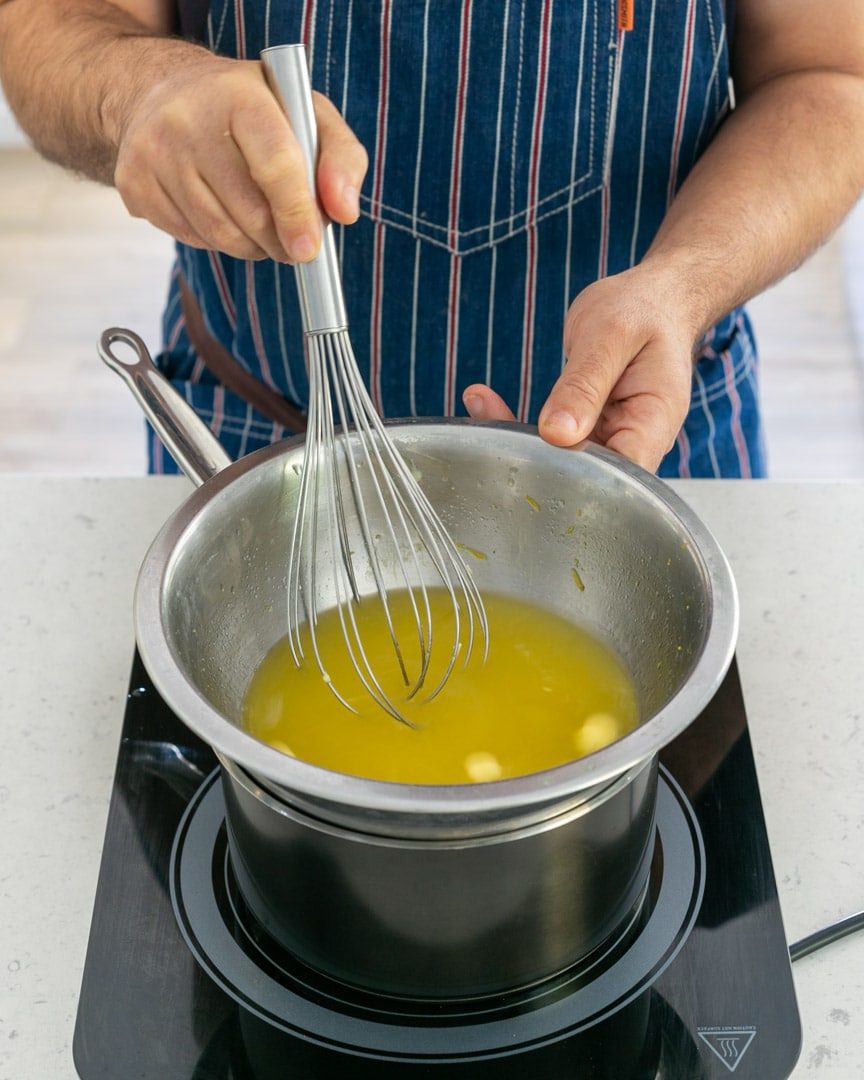 Melting butter with lemon juice and zest on waterbath