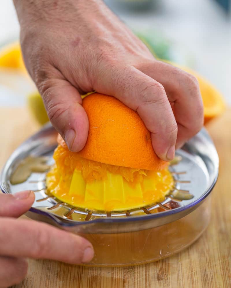 Squeezing orange juice using a juicer