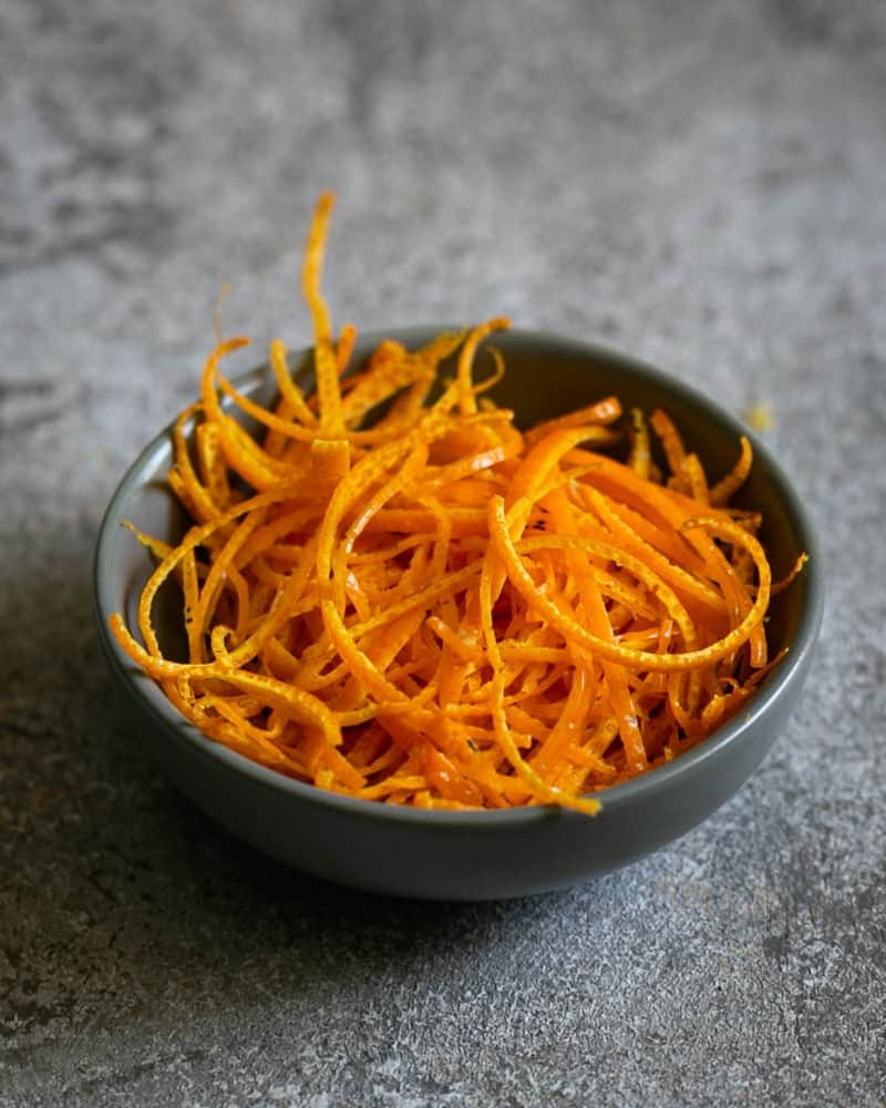 Orange zest julienne in a grey pinch bowl