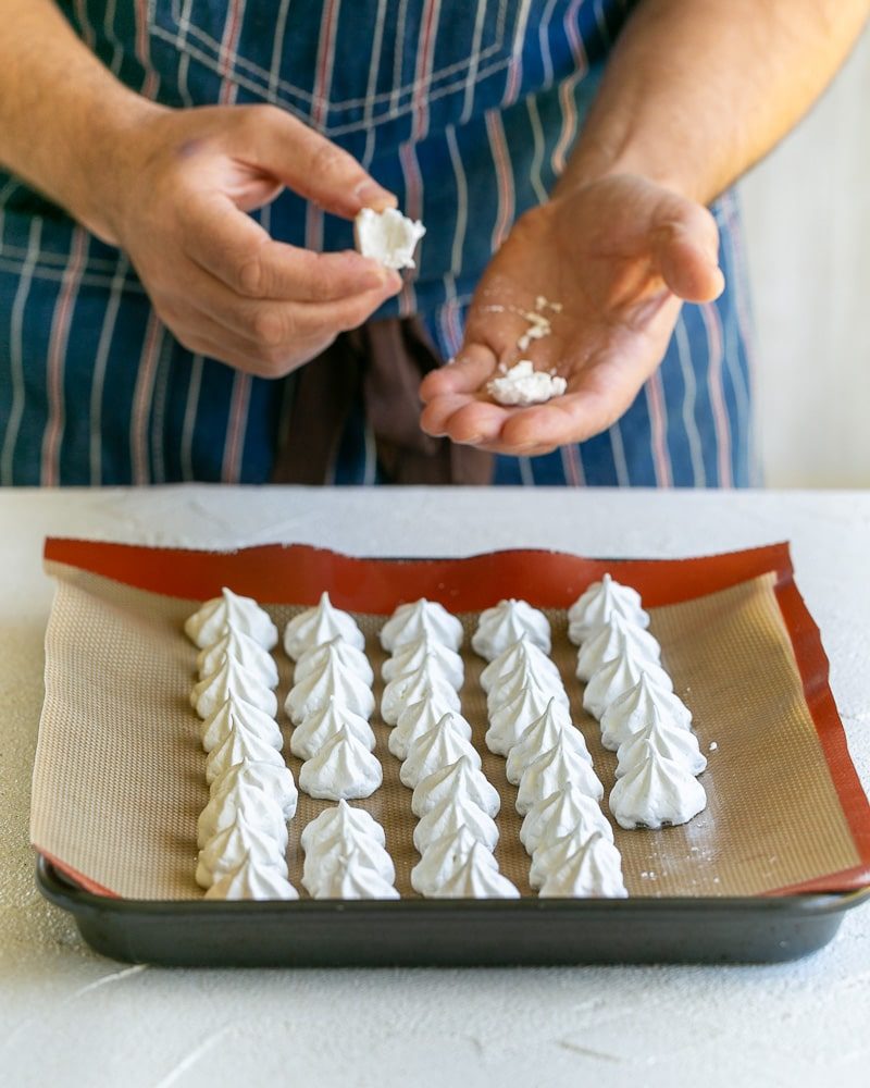 Done Meringue drops on a baking tray