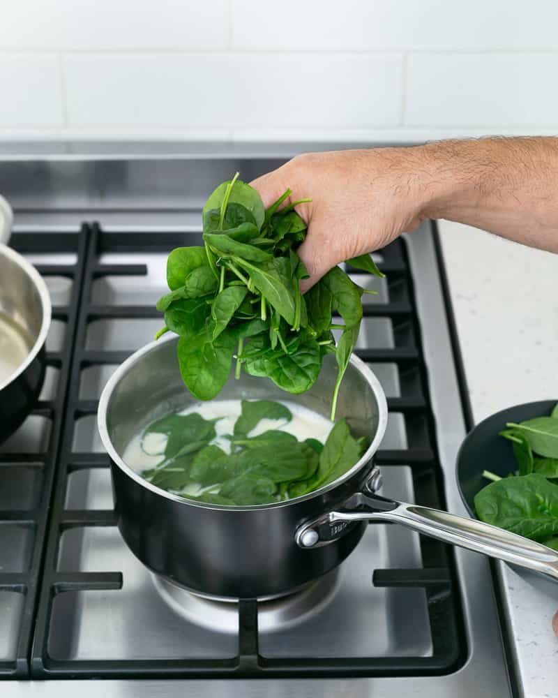 Add fresh spinach to the vegetable and cream stock