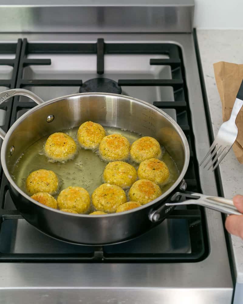 Deep frying paneer potato dumplings in oil