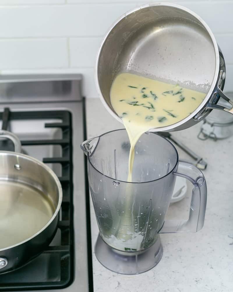 Spinach vegetable cream stock transferred to blender for to make spinach sauce