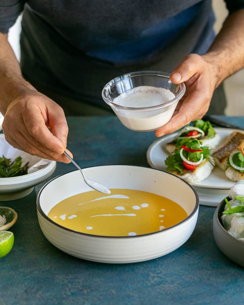 Coconut cream drizzled on the coconut curry sauce in the bowl