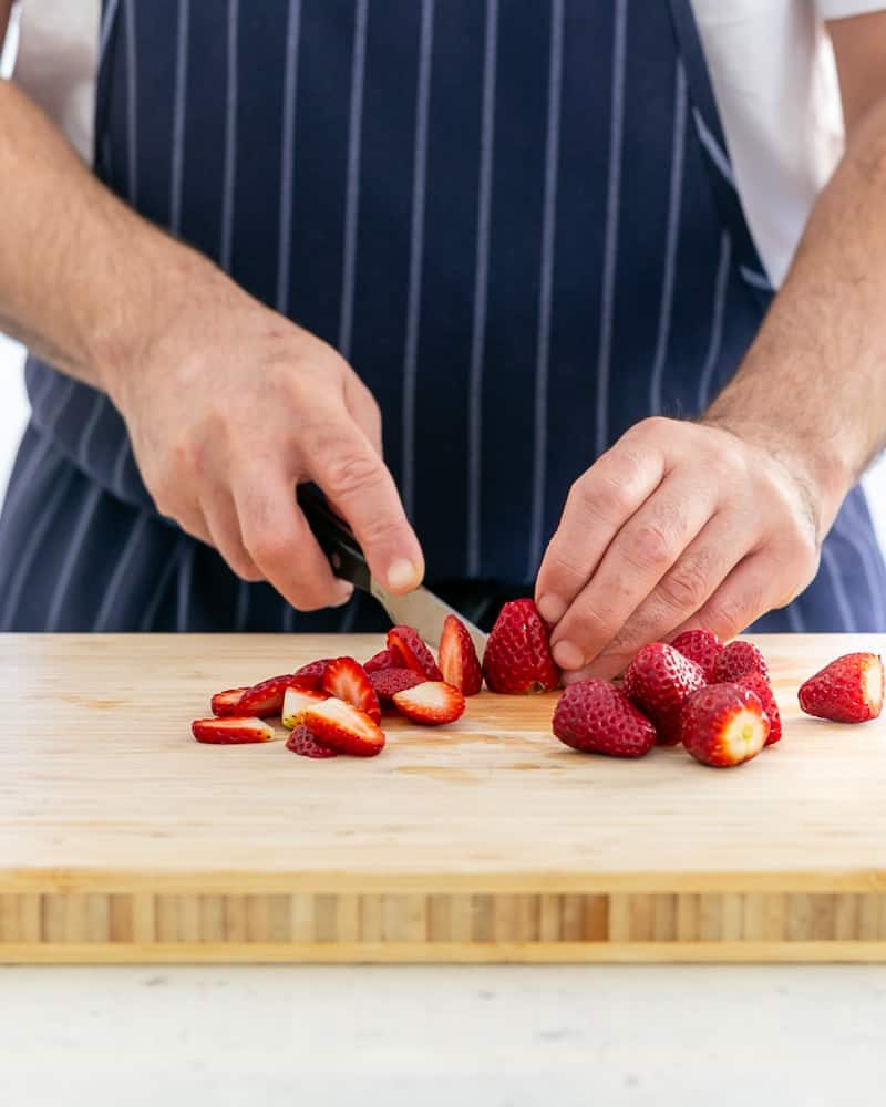 Slicing strawberries for Poached Rhubarb with Strawberries and Coconut Chantilly