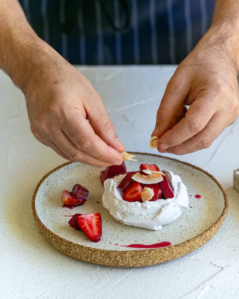 Garnishing dessert with toasted coconut flakes