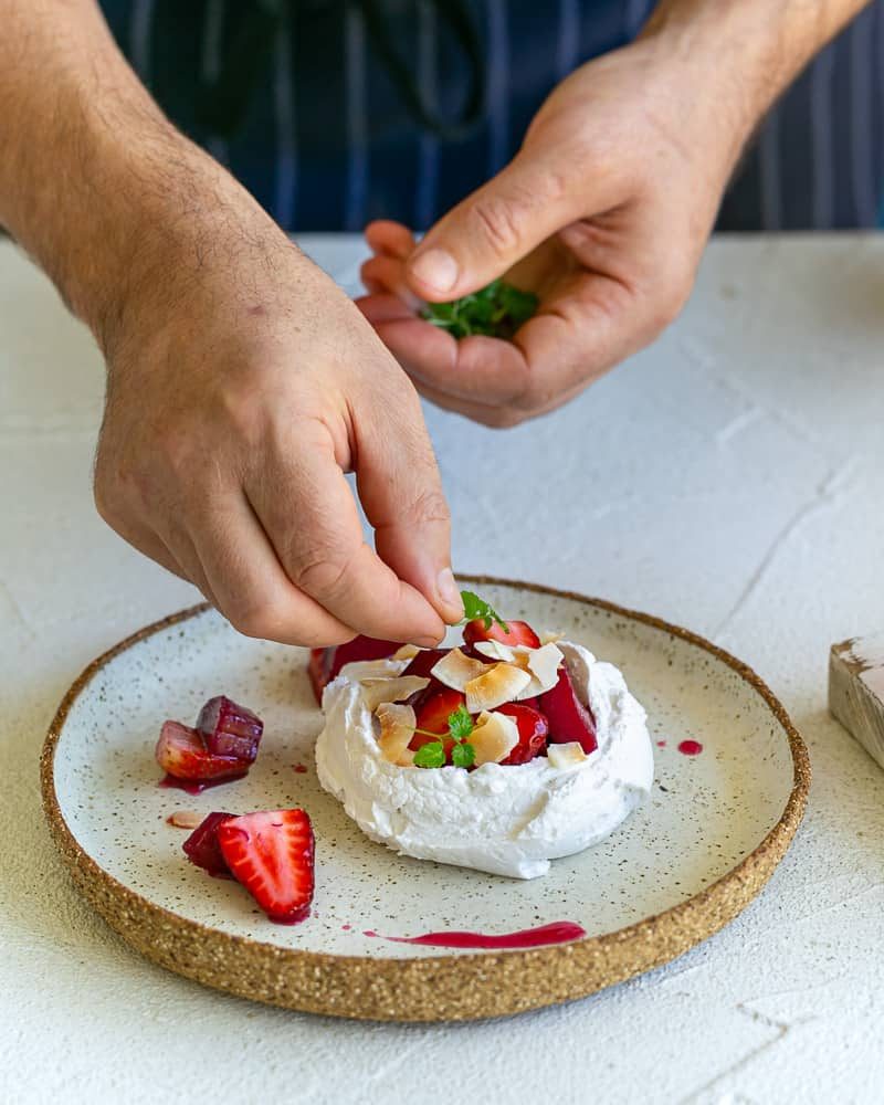 Adding Lemon balm leaves on the dessert