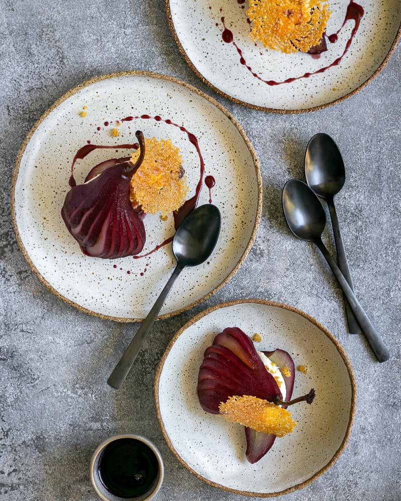 Spiced Poached pears with mascarpone in plates overhead picture