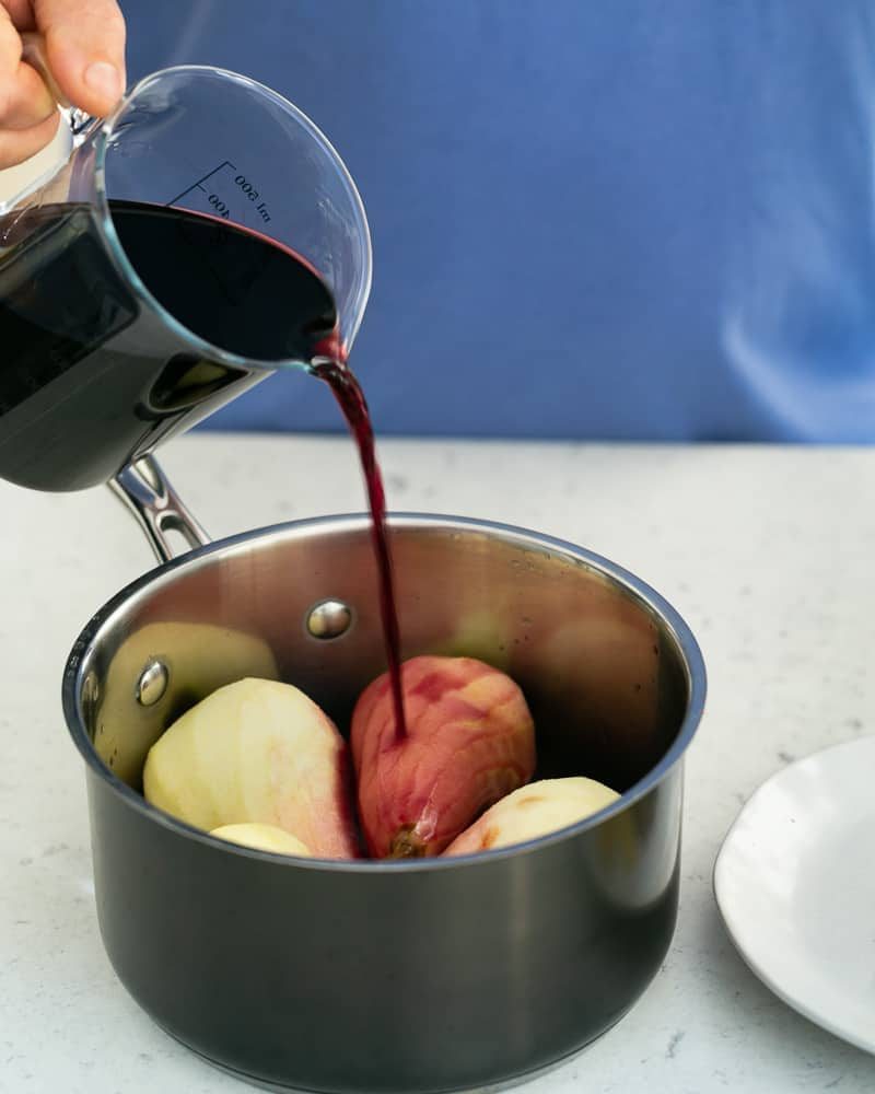 Pour the red wine into the pot with the pears