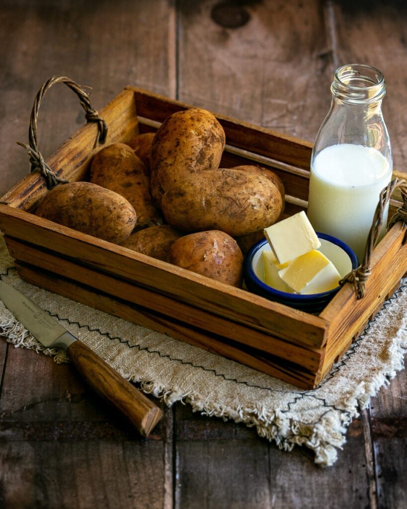 wooden grate with potatoes, milk and butter