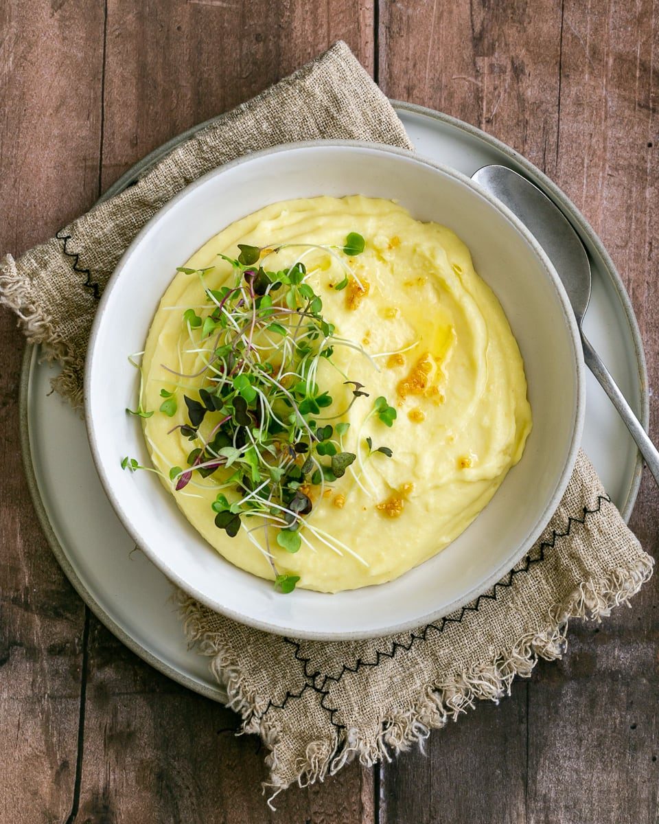 Classic Creamy Mashed Potato dressed with fresh herbs and drizzled with butter