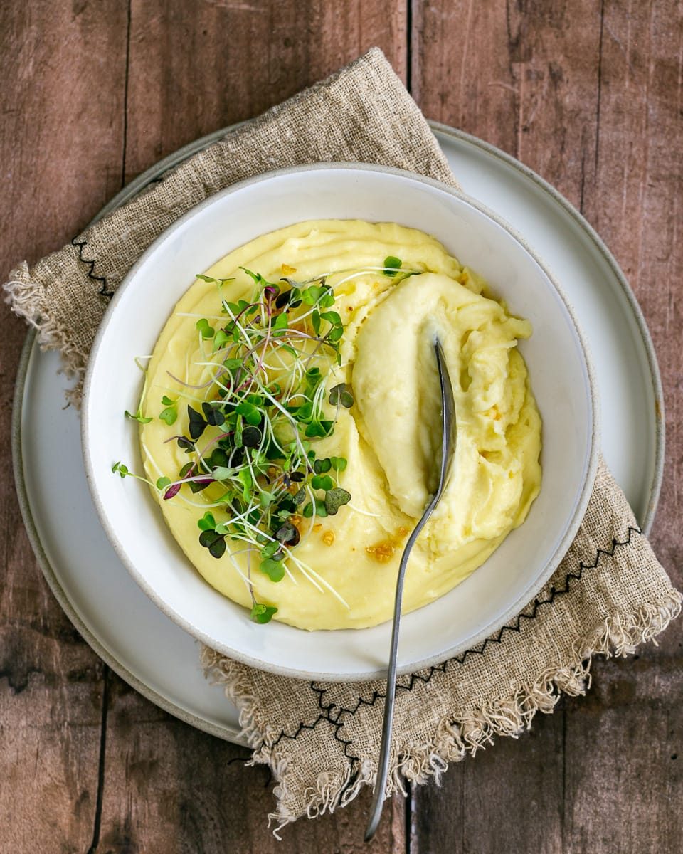 Creamy mashed potato in a bowl with a spoon