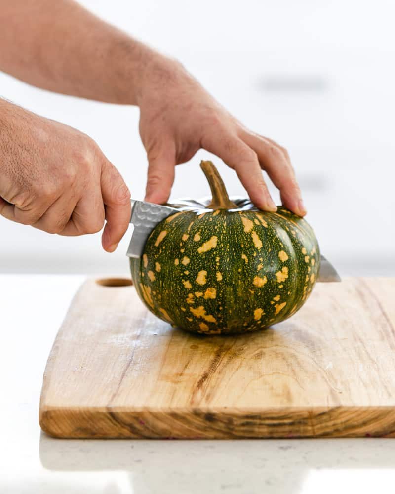 Cutting the Jap pumpkin in half with a sharp knife