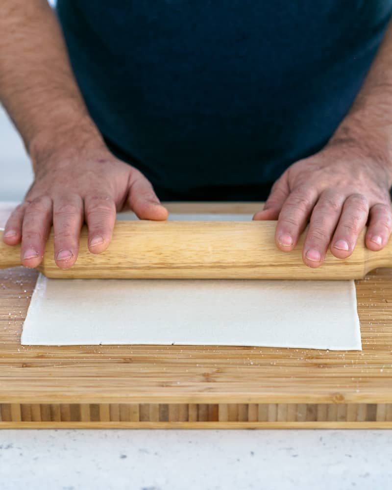 Person rolling sugar on rolled out puff pastry for Dulce de leche Verrine with Banana and whipped Cream