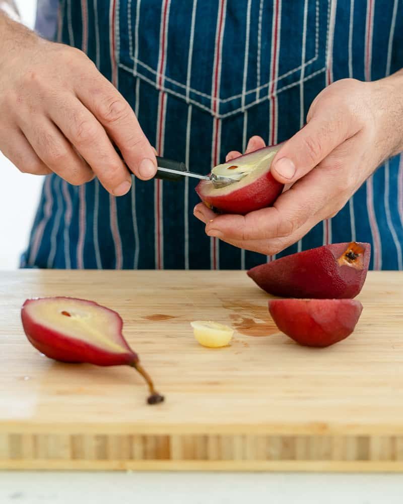 Scooping the centre of a poached pear for assembling Spiced poached pears with mascarpone