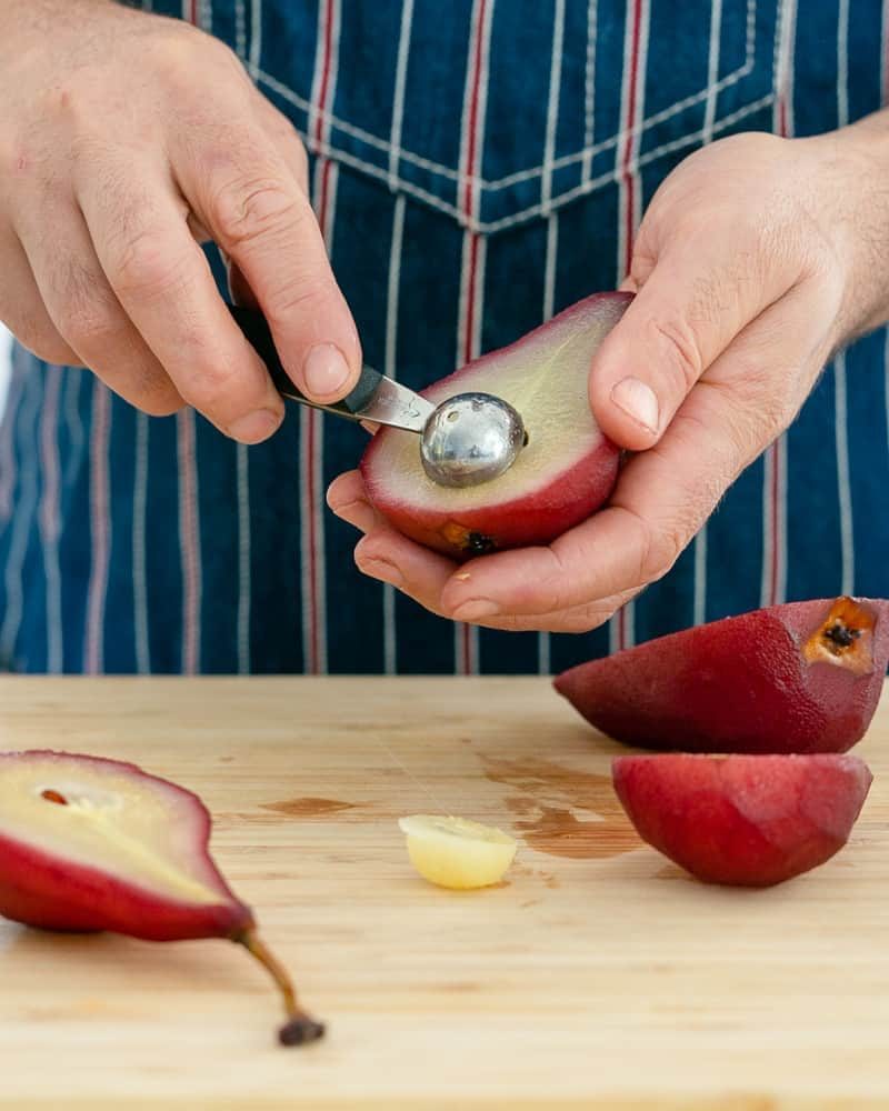Scooping the centre of a poached pear for assembling Spiced poached pears with mascarpone