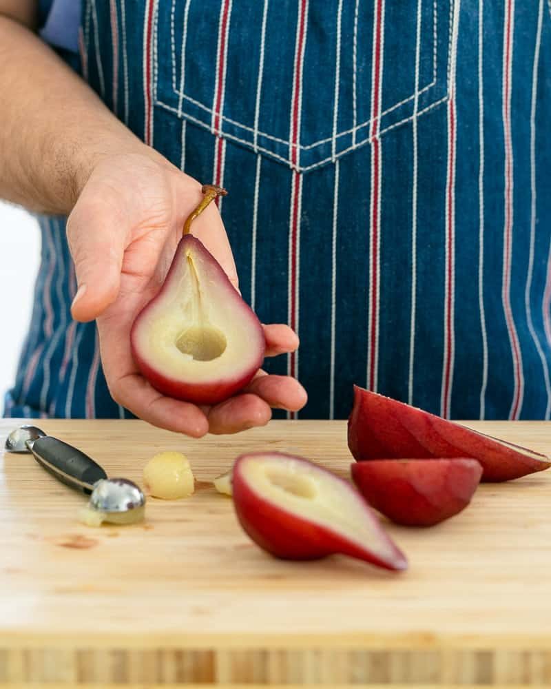 Scooping the centre of a poached pear for assembling Spiced poached pears with mascarpone