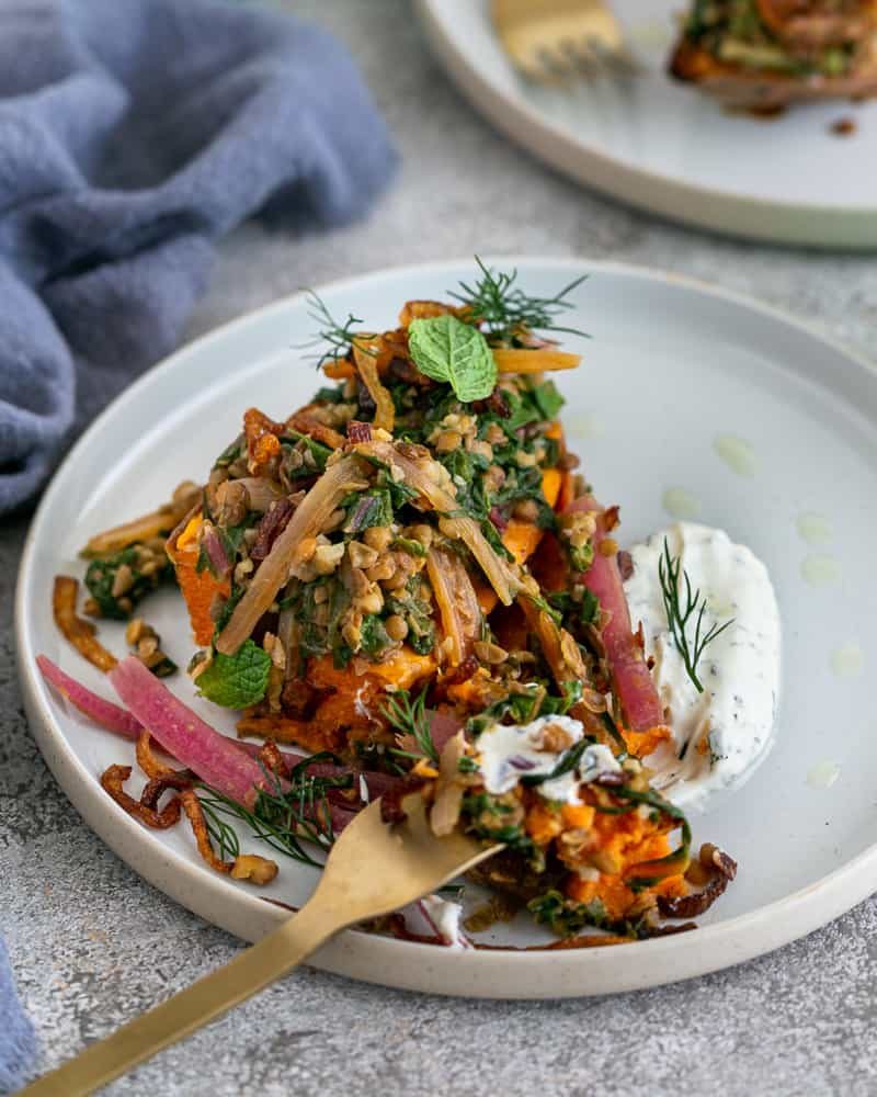 Baked sweet Potato with Lentils and Swiss Chard served in a plate like in a restaurant