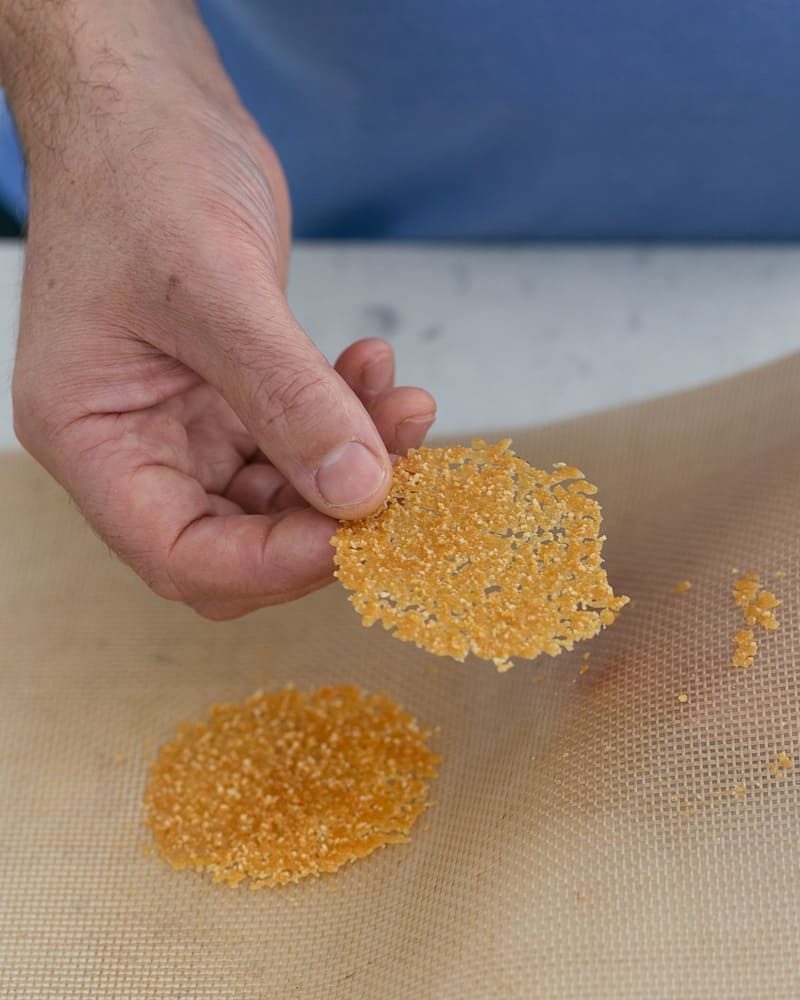 Showing crispness of the baked touile to be used as a garnish for spiced poached pears with mascarpone