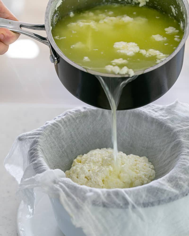 Pour the whey and any left over curdled milk into the muslin cloth to make paneer