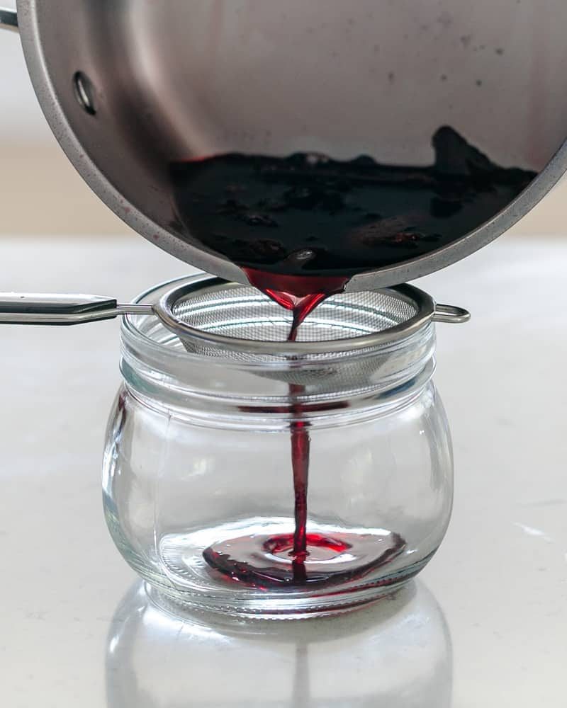 Pouring the wine syrup into a glass jar