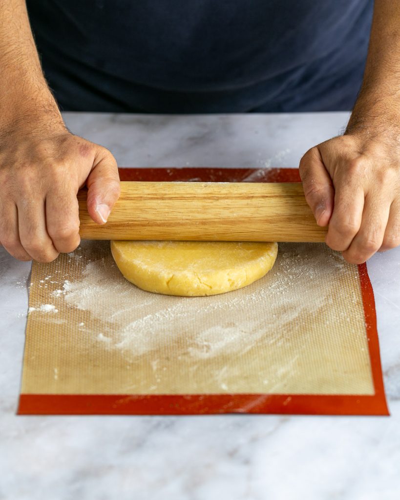 Rolling out the pastry dough to make crostata