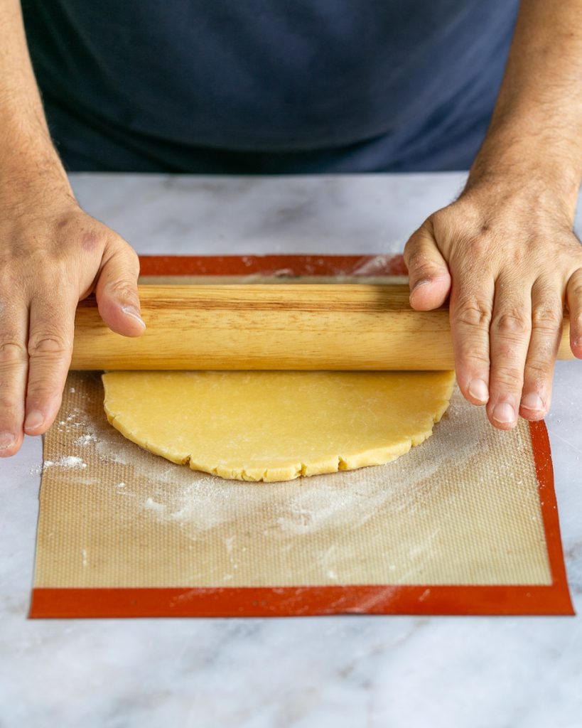 Rolling out the pastry dough to make crostata