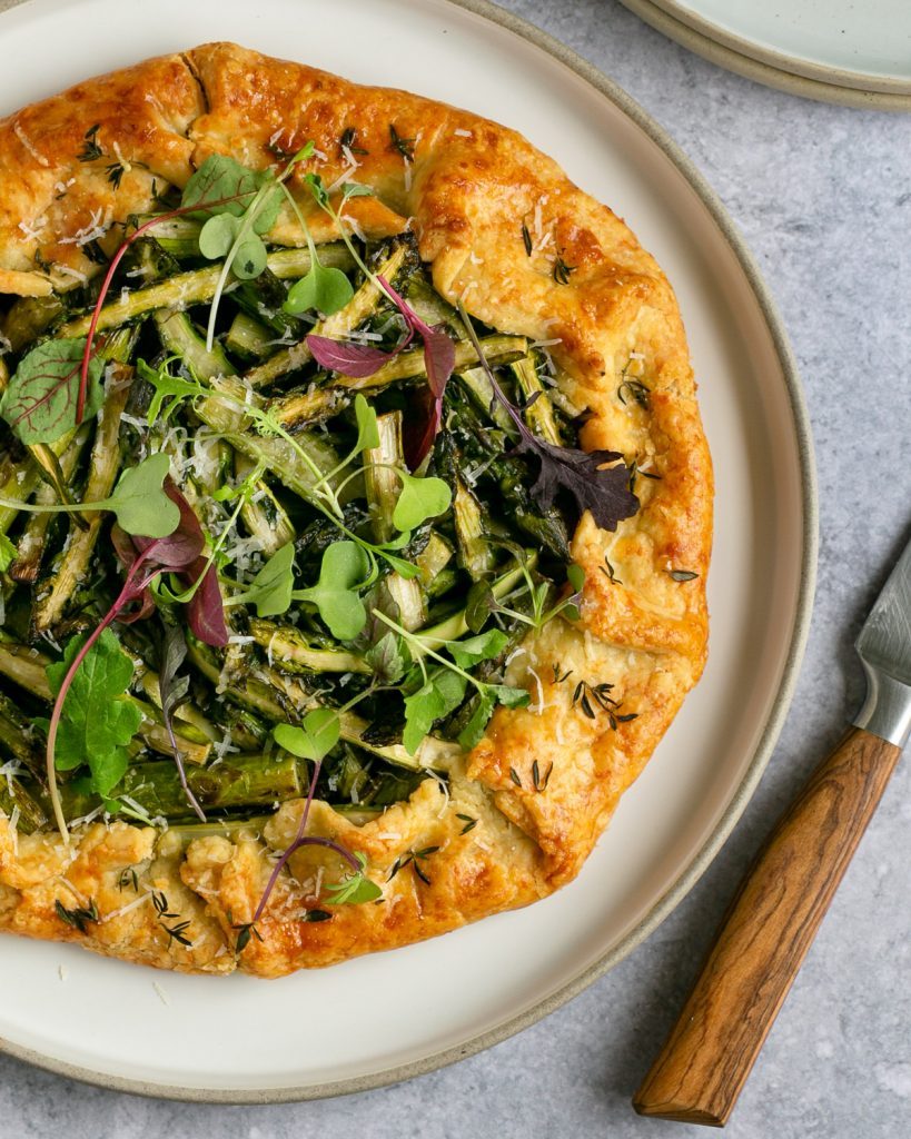 Freshly baked Asparagus and Parmesan Crostata with caramelised onions