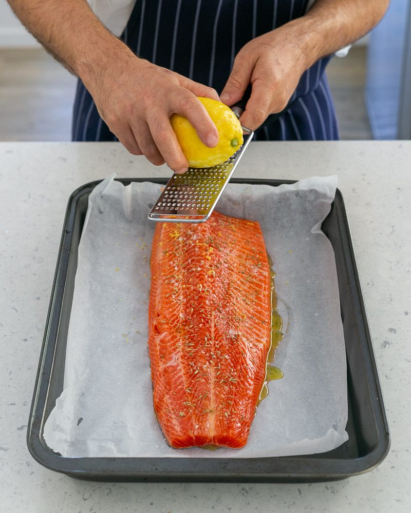 Adding grated zest on trout fillet