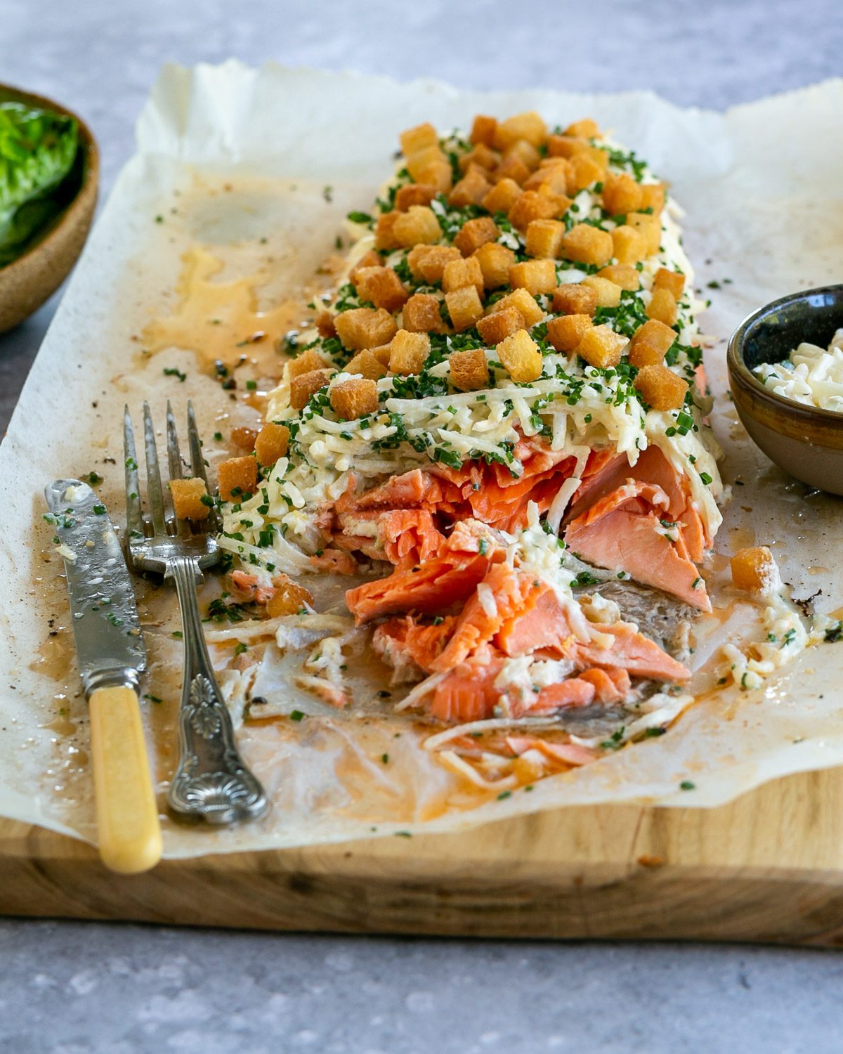 Flaked baked trout fillet served on a wooden board