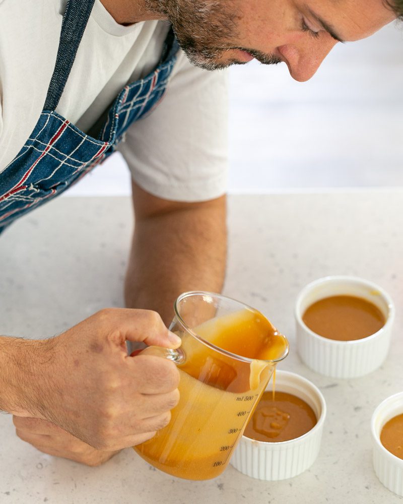 Filling the ramekins with the salted caramel fondant batter