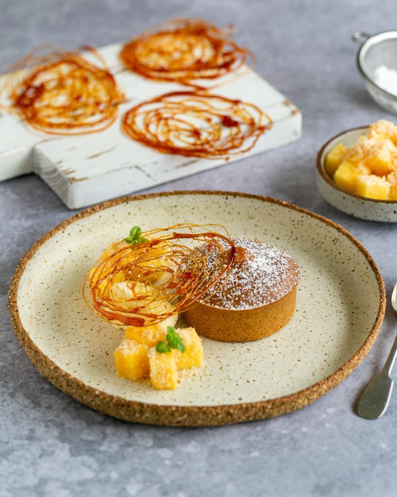 plate up of a Salted caramel fondant with mango