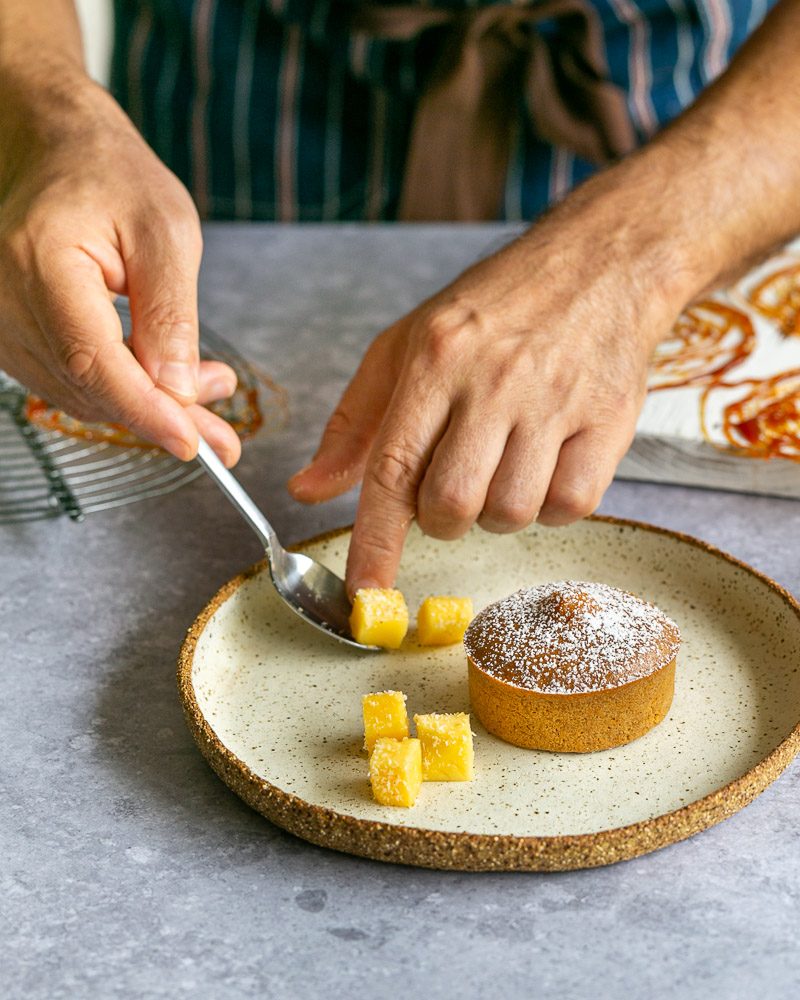 Adding mango cubes to the dessert plate as garnish