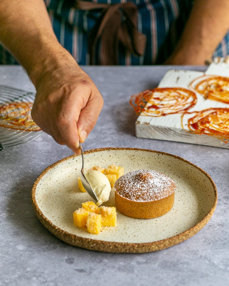 Spoon of mascarpone added to the dessert plate