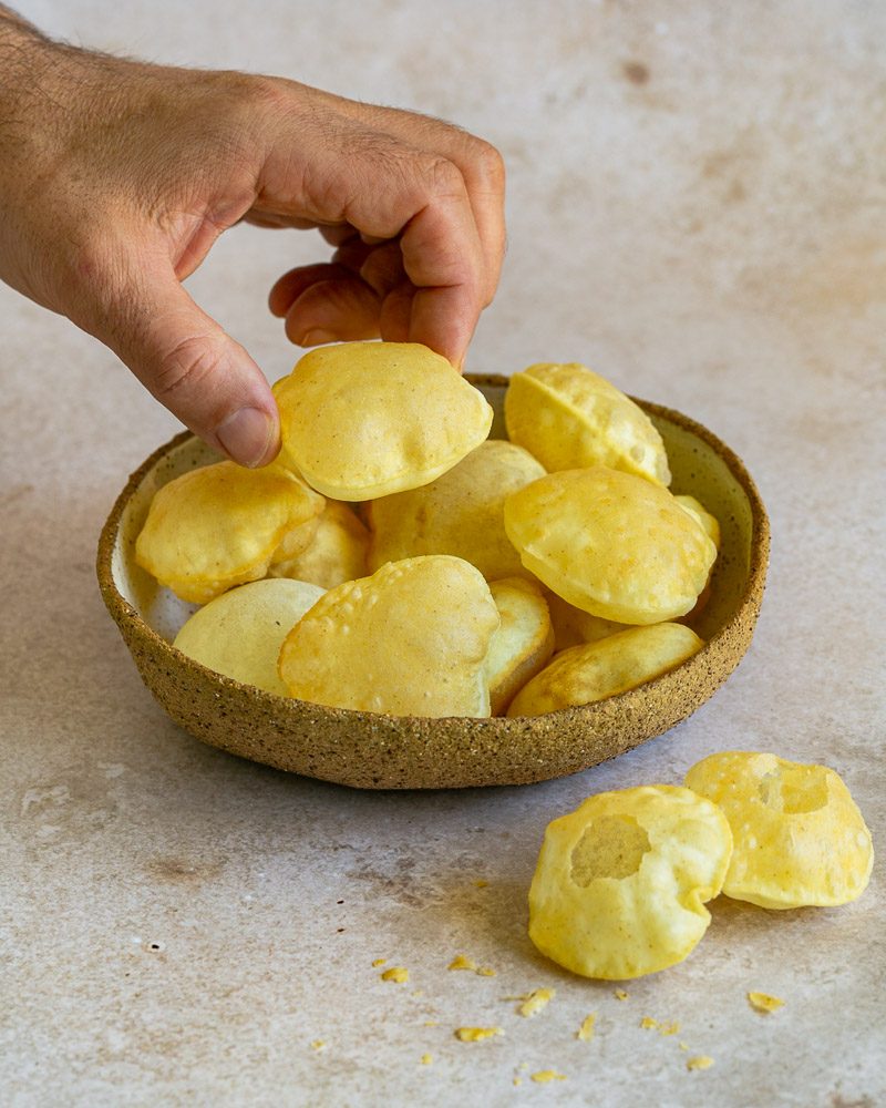 Freshly prepared puffed up puri balls in a bowl for the indian snack puri chaat