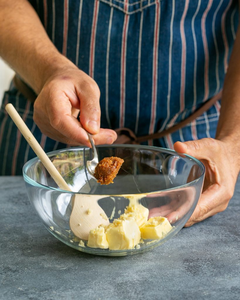 Adding miso to butter in a bowl