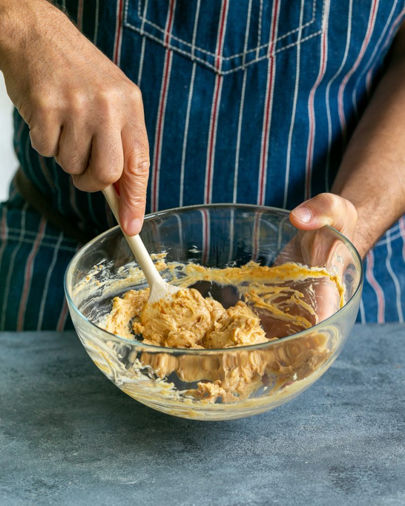 Mixing miso into butter with a wooden spoon