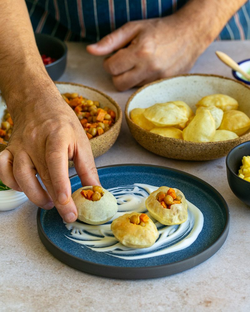 Assembling the puri bites with prepared filling