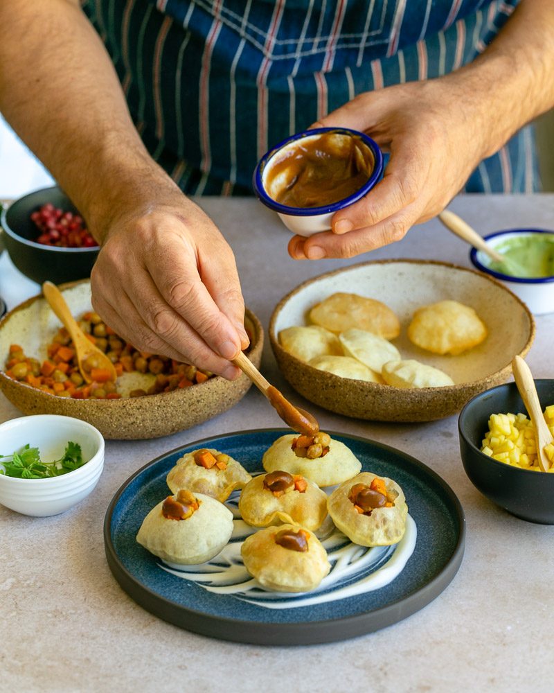 Assembling the puri bites with prepared filling