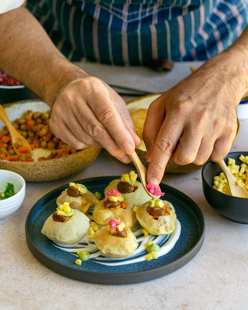 Assembling the puri bites with prepared filling